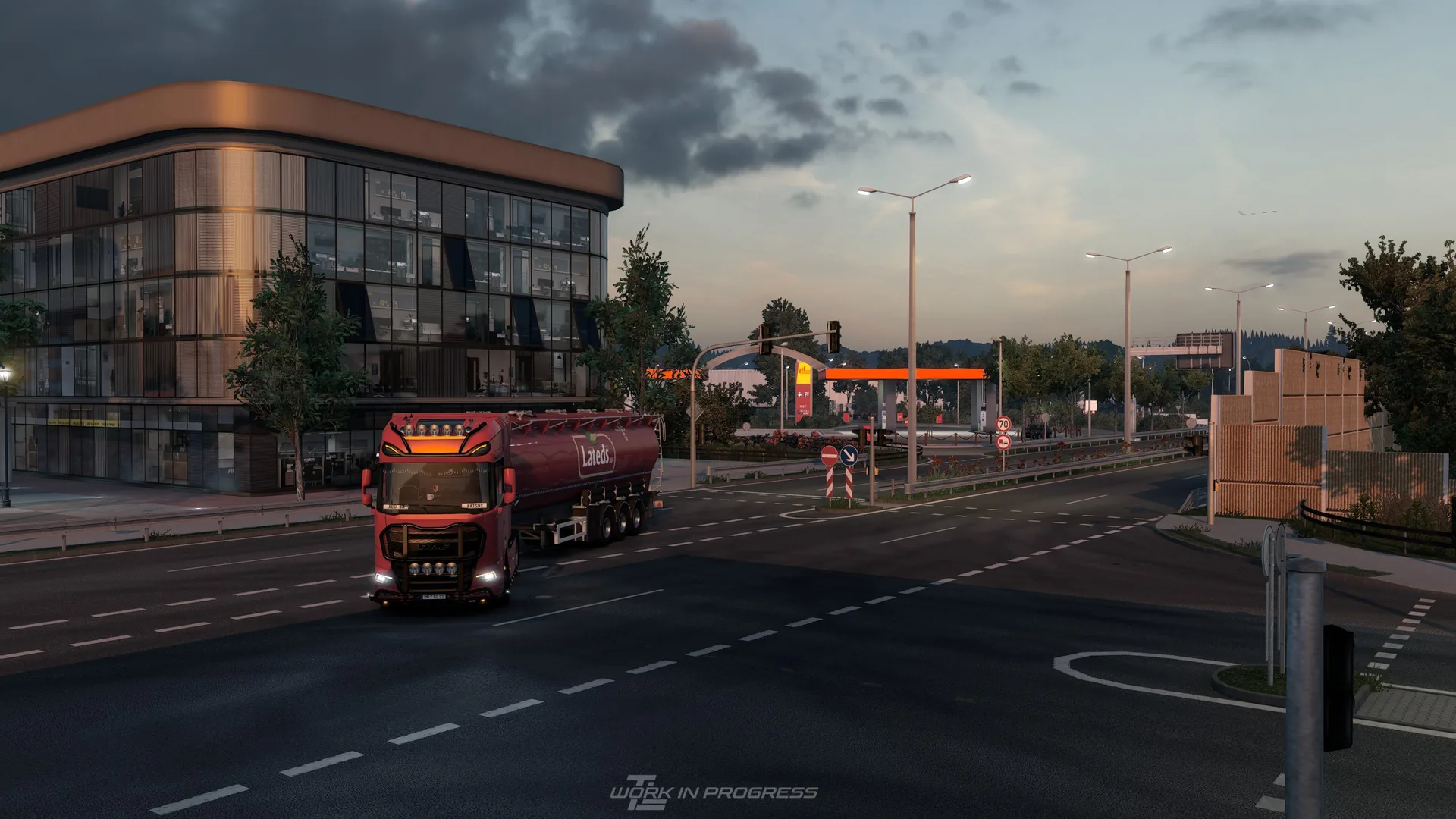 A TrucklineMP truck driving through a city at dusk